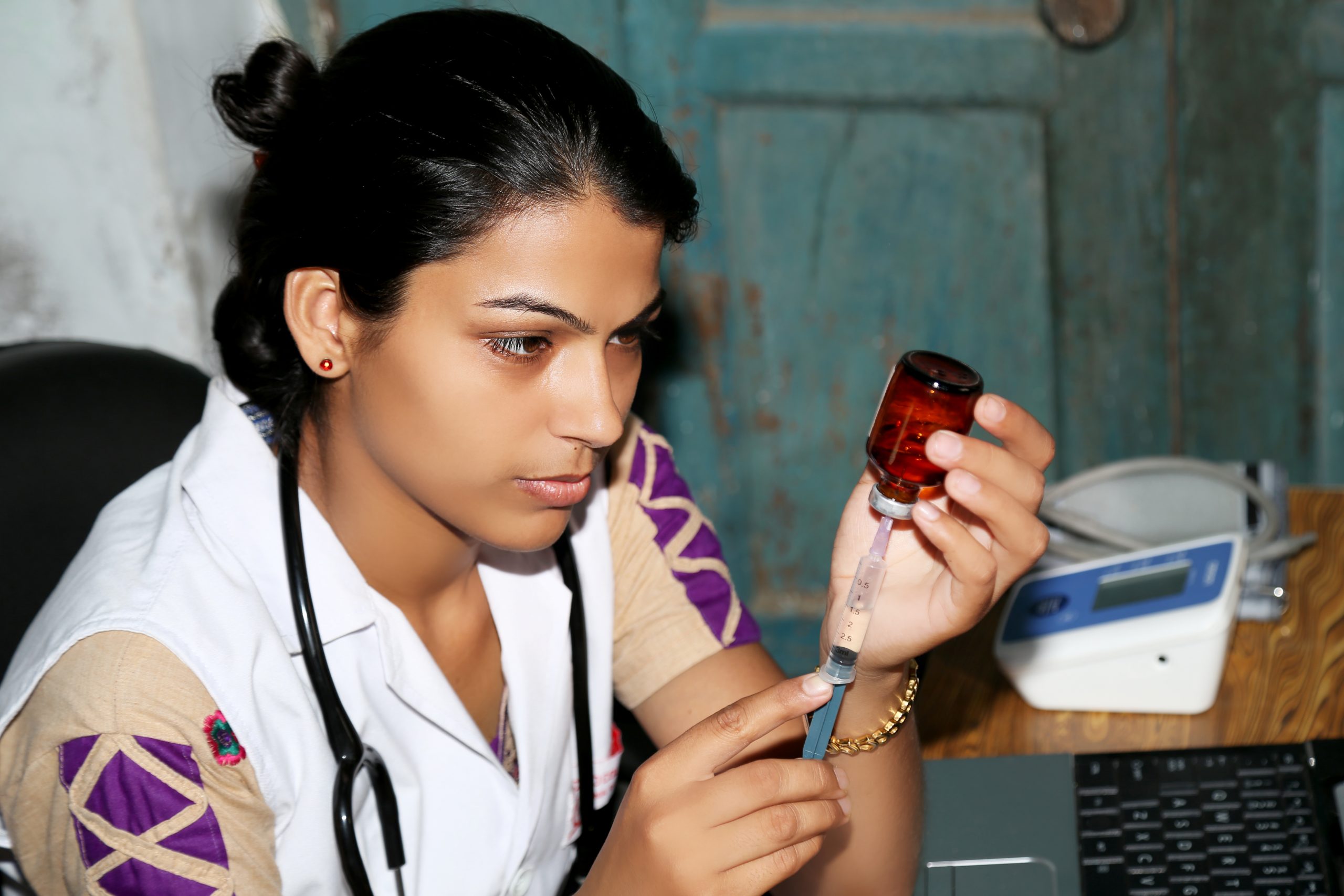 Female doctor preparing injection in clinic