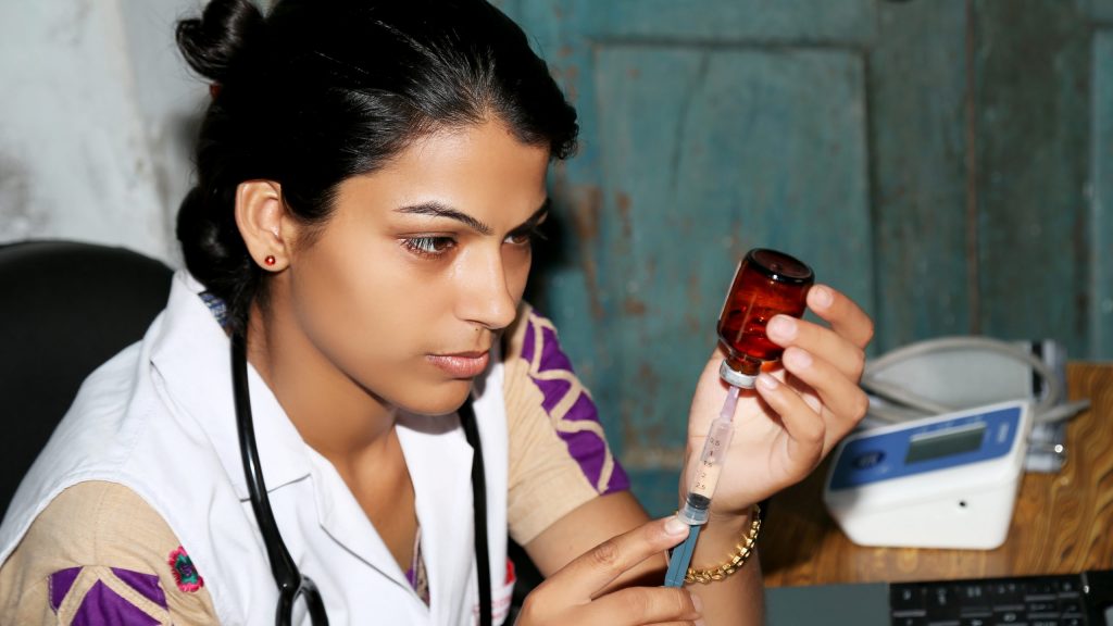 Female doctor preparing injection in clinic