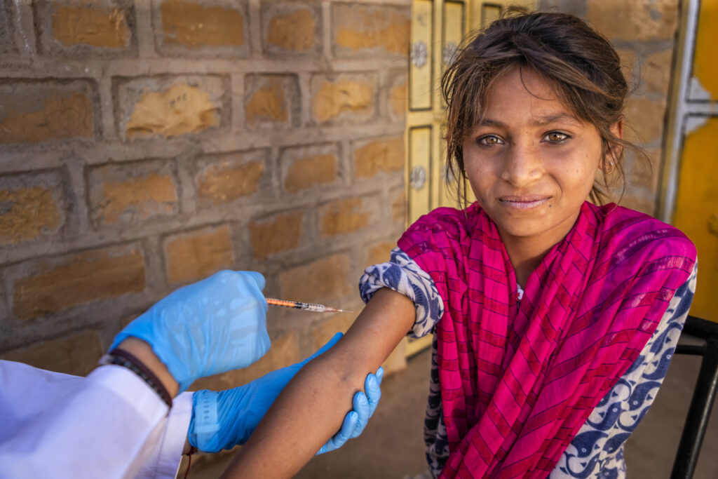Young Indian girl receiving vaccine