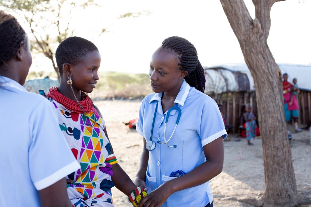 Nurses examining patient in rural village. Kenya, Africa